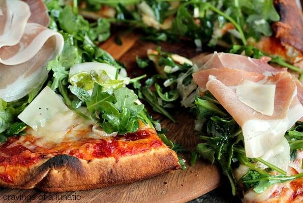 Prosciutto & Arugula, Sausage & Onions Pizza.